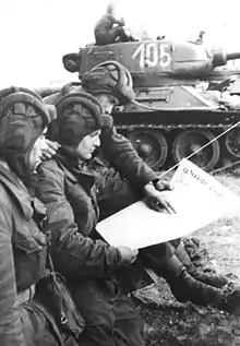 Image 36Soldiers in an East German tank unit reading about the erection of the Berlin Wall in 1961 in Neues Deutschland (from Newspaper)