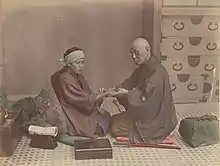 Image 14A doctor checks a patient's pulse in Meiji-era Japan. (from History of medicine)