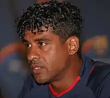 A man wearing a blue and red shirt.