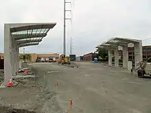 Concrete bus shelters next to an graded loop road