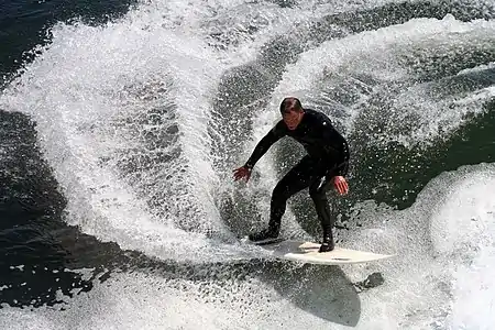 Image 19SurfingPhoto credit: Mila ZinkovaA surfer off the coast of Santa Cruz, California, is performing a "cutback", or very sharp turn. Santa Cruz and the surrounding Northern California coastline is a popular surfing destination; however, the year-round low temperature of the Pacific Ocean in that region (averaging 57 °F or 14 °C) necessitates the use of wetsuits.More selected pictures