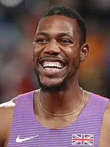 Headshot of a black man in a dark blue and white Team GB top.