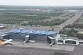 An aerial view of International Terminal 1 in July 2021 including the Astana Light Metro in the back