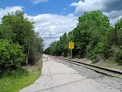 View of the access road for the former MBTA layover yard at East Junction; this section of track is currently disused