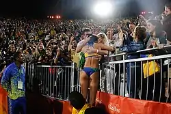 Image 26Ágatha Bednarczuk embraces the home crowd after the 2016 final. (from Beach volleyball at the Summer Olympics)