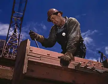 Image 3RiggerPhoto credit: Alfred T. Palmer"Big Pete" Ramagos, rigger at work on Douglas Dam, Tennessee, June 1942. A rigger is a person or company which specializes in the lifting and/or moving of extremely large and/or heavy objects. Riggers use equipment expressly designed for moving and lifting objects where ordinary material handling equipment cannot go.More selected pictures
