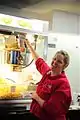 Army and Air Force Exchange Service worker making popcorn in a modern popcorn maker