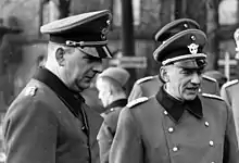 a black and white photograph of two men in uniform