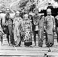 People in traditional attire. The man on the right hand side has stripes.