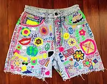 Image 7Acid washed jean shorts with grunge and hippie inspired DIY slogans and pictures. (from 1990s in fashion)