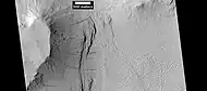 Layers under cap rock of a pedestal crater, as seen by HiRISE under HiWish program.  Pedestal crater is within the much larger Tikhonravov Crater.