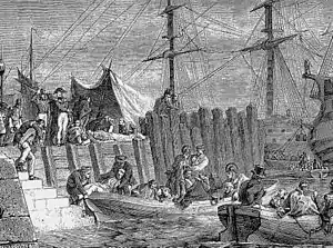 Etching of a dockside where sick troops are loaded onto boats which take them to awaiting ships