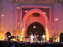 Concert stage with a band preforming and the gate of Bab Dekkakin in the background
