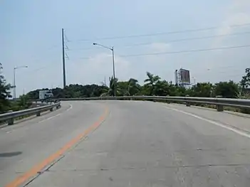 Steel pole 474 near Dulalia Overpass in Valenzuela. Originally had a triangle design from 1994 to 2007, the said pole was changed to flag design when it was replaced by newer and higher ones due to the construction of an overpass mentioned before (and also the NAPOCOR-era steel pole 474 was later used on one of the bipole towers of Mexico–Hermosa Transmission Line).