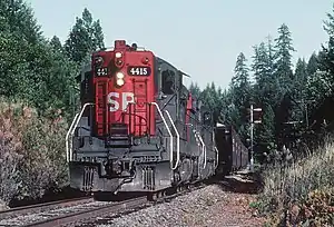 Southern Pacific SD9E units #4415 at Signal 4955 between Leland and Wolf Creek, Oregon in July of 1982
