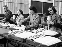 Image 10Workers inspecting practice bombs at a factory in South Australia during 1943 (from Military history of Australia during World War II)