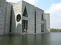 Image 53Jatiyo Sangsad Bhaban is the National Assembly Building of Bangladesh, located in the capital Dhaka. It was created by architect Louis I. Kahn and is one of the largest legislative complexes in the world. It houses all parliamentary activities of Bangladesh. This photo offers a close view of a section of the parliament building.Photo Credit: justinstravels