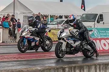 Two BMW S 1000 RR motorbikes at a drag race