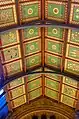 The painted ceiling, North Hall, Natural History Museum c.1881, designed by Waterhouse, painted by Charles James Lea of the firm of Best & Lea, depicting native British plants,  subdued colour palette with subtle gilded highlights is used, note the unobtrusive cast-iron roof trusses, very different from his wooden roofs
