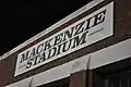 A stadium sign located near the left field entrance.