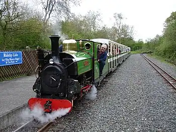 Image 41Ruislip Lido Railway's 12-inch (300 mm) gauge locomotive "Mad Bess" hauling a passenger train.