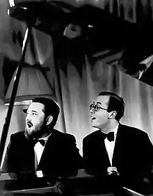 black and white photo of Flanders and Swann at the piano singing