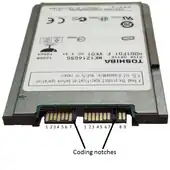 A 1.8-inch micro SATA hard drive with numbered data and power pins on the connector.