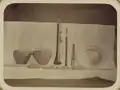Two pairs of qairaq lie in a line beneath the other instruments. Top row, far right is the tas.