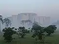 Image 52Jatiyo Sangsad Bhaban is the National Assembly Building of Bangladesh, located in the capital Dhaka. It was created by architect Louis I. Kahn and is one of the largest legislative complexes in the world. It houses all parliamentary activities of Bangladesh. This photo offers a view of the parliament building during sunrise.Photo Credit: Lykantrop