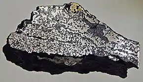 Image 14A sample of Siberian Traps basalt (dark) containing native iron (from Siberian Traps)