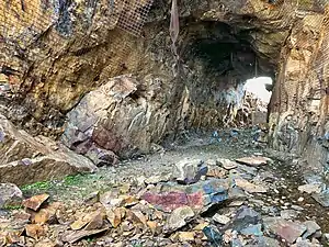 2018 photograph of Needle's Eye Tunnel, near the summit of Rollins Pass. This view shows the northeast portal in the foreground; the southwest portal can be seen in the background. Wire mesh and metal dowels were installed in August 1987 to help reduce additional rock falls and preserve the condition of the tunnel constructed in 1903 (120 years ago) (1903).