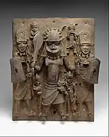 Plaque with warriors and attendants; by artists of the Edo people; 16th-17th century (Nigeria); brass; height: 47.6 cm; Metropolitan Museum of Art