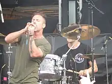 Rymer (right) and Greg Puciato performing with The Dillinger Escape Plan in 2016