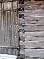 A locked or tooth-edge joint in the door corner of an old wooden storage building at the Lamminaho estate in Vaala, Finland.