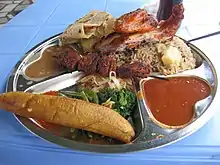 Image 26Traditional Tanzanian food consisting of pilau kuku (seasoned rice with chicken), mishkaki (grilled meat), ndizi (plantain), maharage (beans), mboga (vegetables), chapati (flatbread) and pili pili (hot sauce) (from Culture of Tanzania)