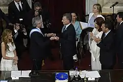 President–elect Alberto Fernández receives the presidential sash and staff from outgoing president Mauricio Macri in 2019