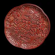 Tray with two birds against a background of plum blossom and flowers, 19 cm wide, late Song, 13th century (oblique view). No overlapping of forms, and relatively wide strips of background visible.