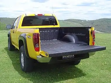 Chevrolet Colorado flat sided pickup truck showing wheel well intrusion into bed