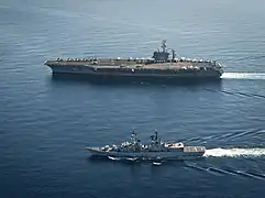 USS Nimitz and Francesco Mimbelli alongside each other in the Mediterranean Sea on 26 October 2013.