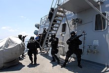 Members of the Brunei Special Forces rush towards the pilot house of USS Howard (DDG-83) during a visit, board, search and seizure exercise on 18 August 2008.