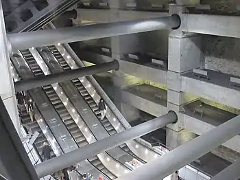 Image 6Escalators at Westminster Underground station descend between beams and columns of the station box to reach the deep-level Jubilee line platforms.