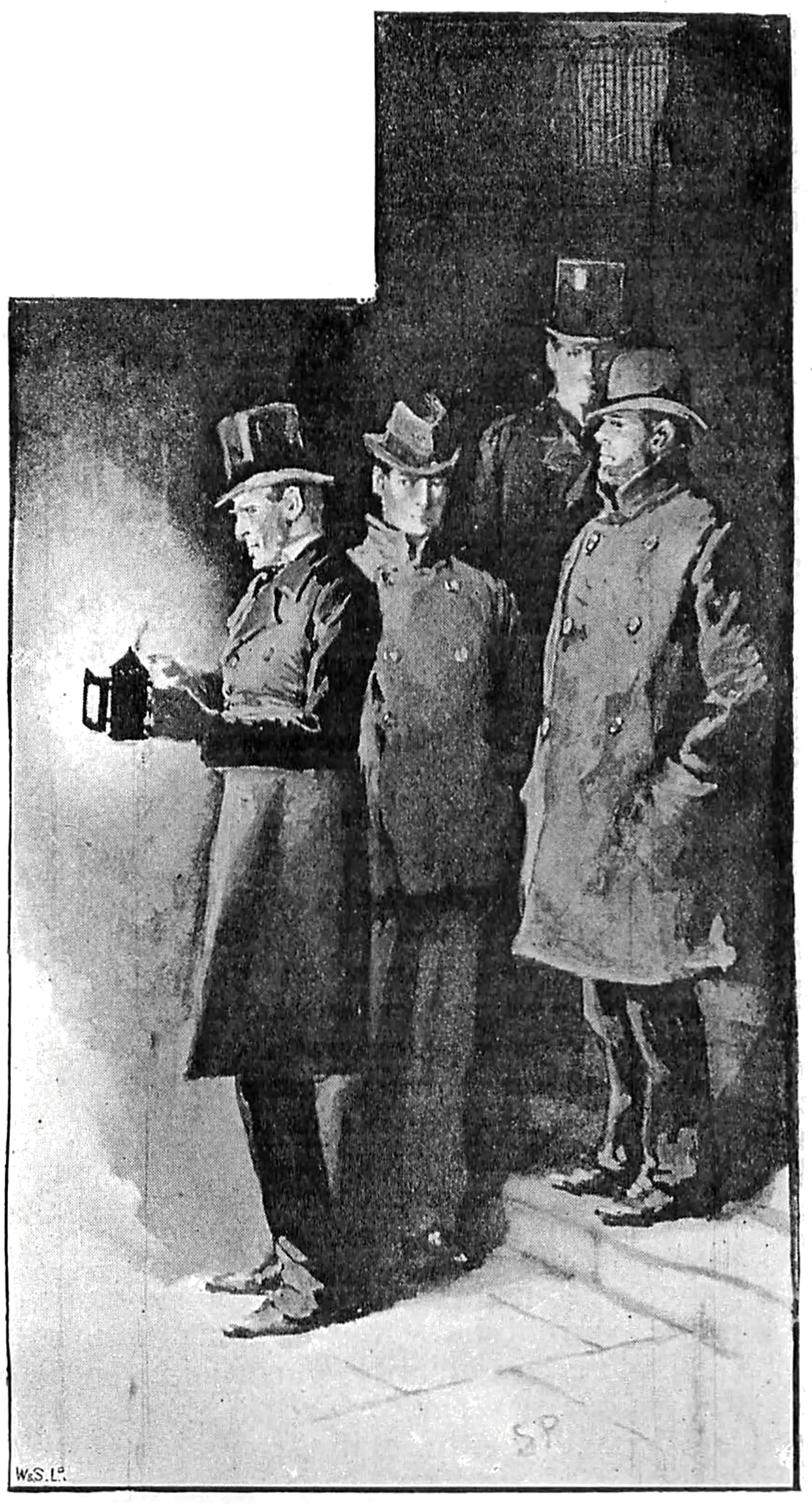 Four people in a group at the bottom of stairs, with one person at the front lighting a lantern