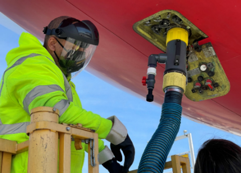 airplane wastewater testing Worker collecting wastewater from an airplane